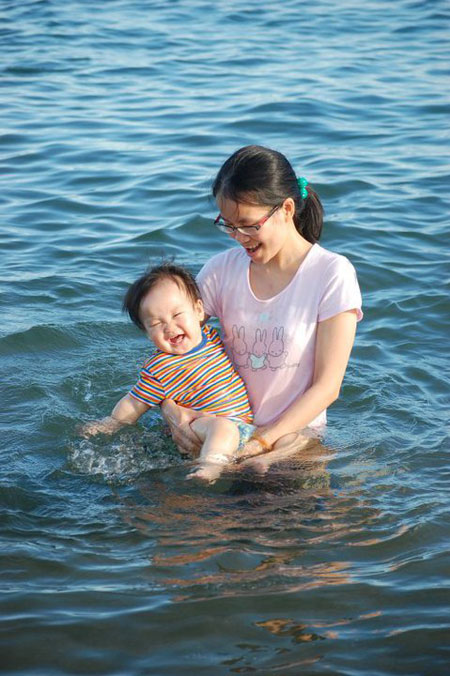 Chị Phạm Thị Thanh Hoa cùng con đang vui đùa dưới nước. Cậu bé có bố là người Nhật tỏ ra rất thích thú khi nghịch nước cùng mẹ.