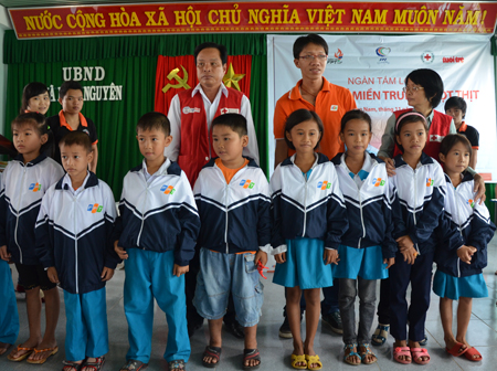 Đại diện FPT và Hội Chữ thập đỏ Quảng Nam chụp hình lưu niệm với học sinh Thăng Bình.