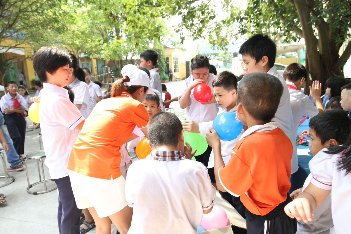 <p> Các tình nguyện viên trong đoàn chia nhau công tác chuẩn bị cho chương trình trao quà và tổ chức Trung thu cho học sinh: người treo phông; người kê bàn ghế; người thổi bóng cùng các bé.</p>