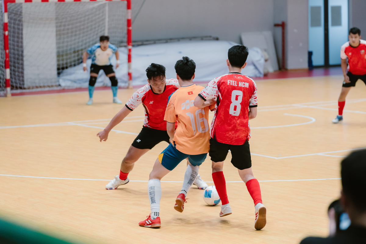 <p class="Normal" style="text-align:justify;"> Trận tranh hạng Ba cúp Vàng giữa FTEL 2 &lpar;đỏ&rpar; và FSOFT 2 &lpar;cam&rpar; diễn ra với thế trận khá cởi mở. Sau bàn mở tỷ số của Phạm Phú Tài ở phút 10, FTEL 2 chơi tự tin hơn, đẩy cao nhịp độ tấn công và không còn giữ cách tiếp cận thận trọng như thời điểm trước đó. Sự ăn ý trong các pha phối hợp giúp đại diện nhà Viễn thông liên tục tạo ra khác biệt.</p>